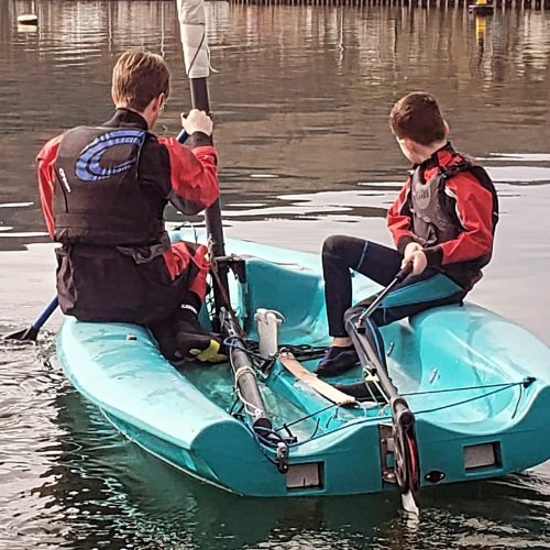 Zach-at-the-helm-on-his-water-sports-intro-course